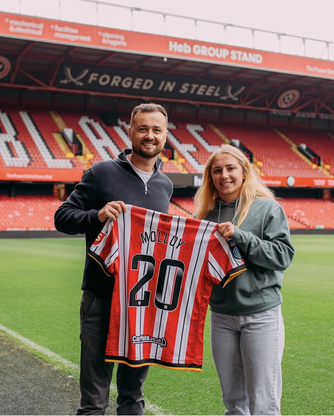 Reliance Talent client holding a personalised Sheffield United shirt at Bramall Lane