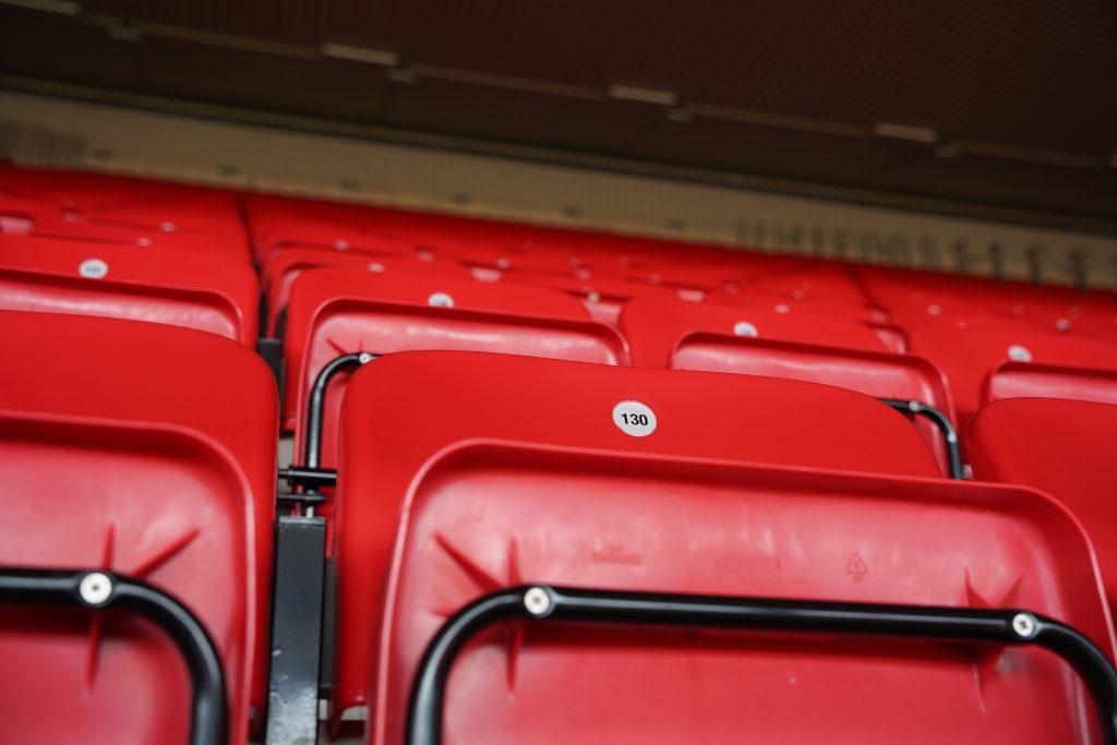 Close-up of empty red stadium seating